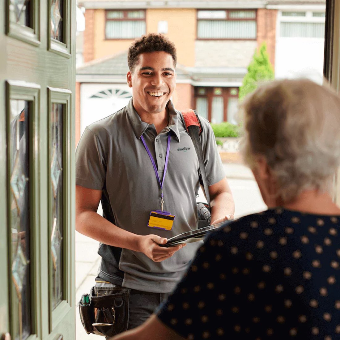 A Dwellow engineer greeting a customer at the front door