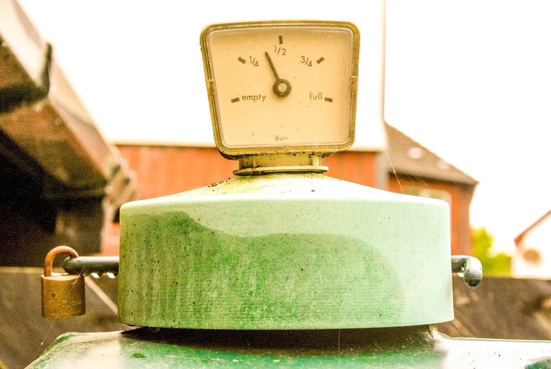 An oil tank gauge between a quarter and half full